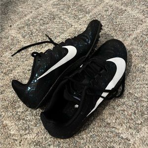 Size 8.5 Black Nike Track Spikes with some blue/purple spots on it